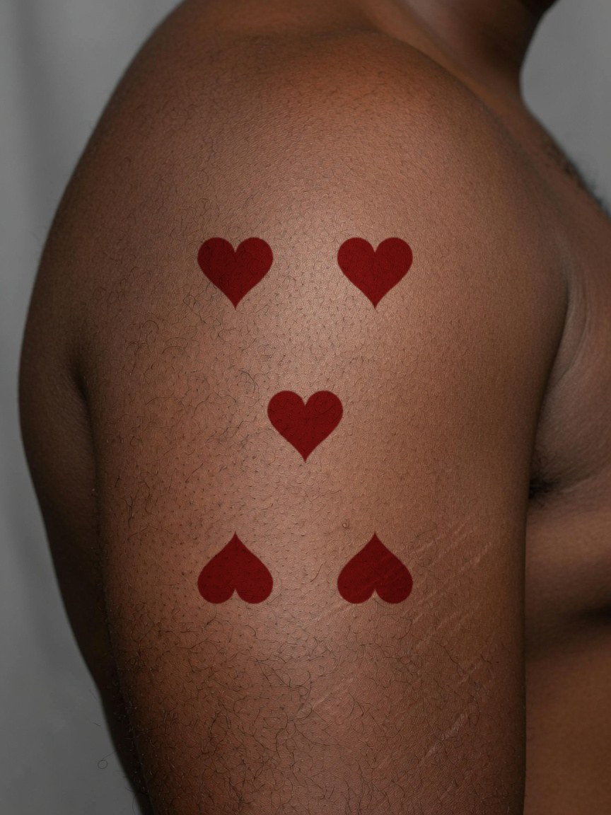 5 of Hearts pip tattoo on the upper arm